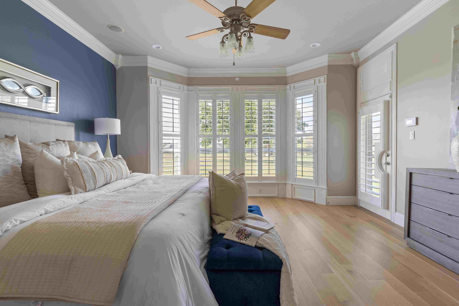 Primary bedroom with bay windows, pasture view, and patio access