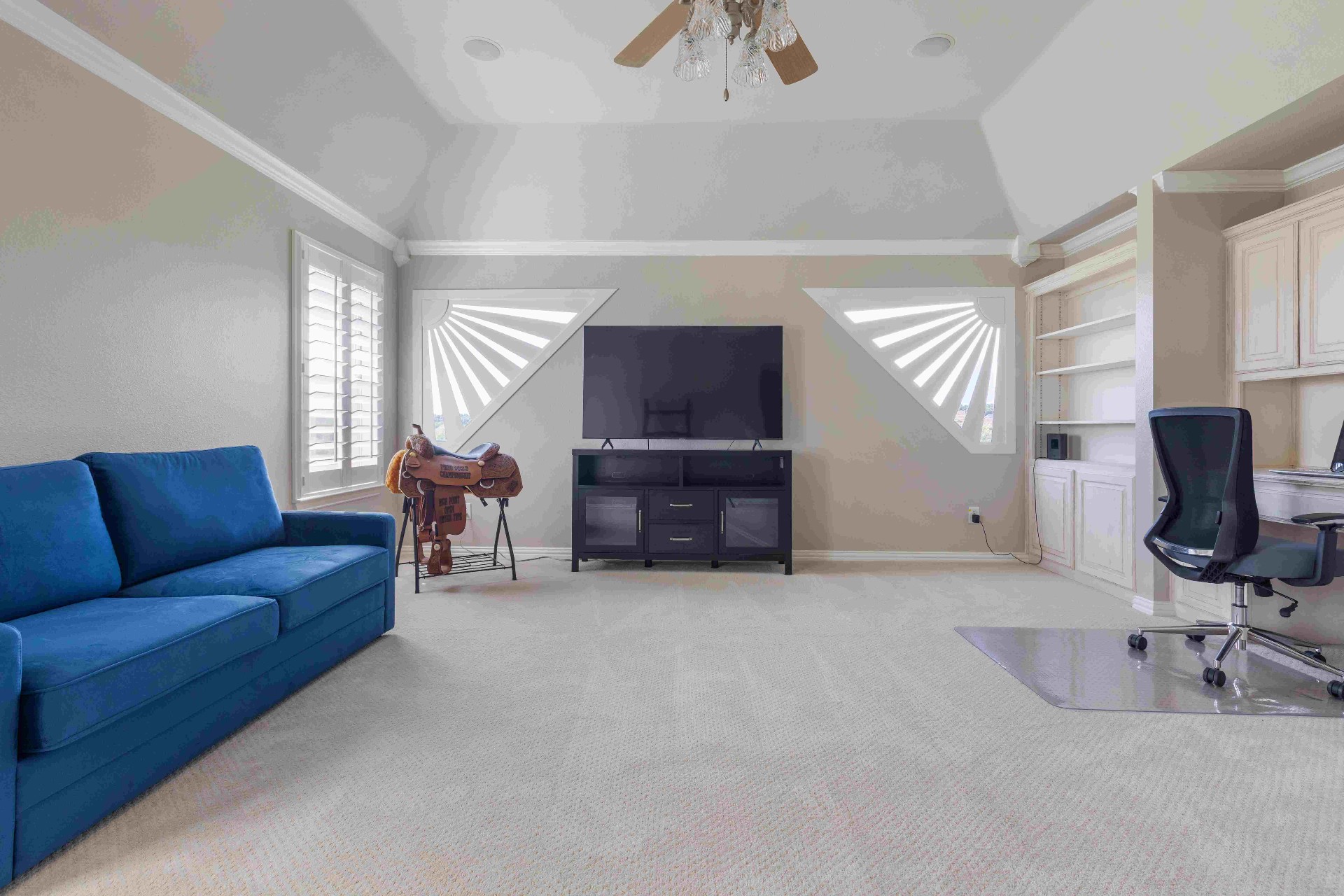 Upstairs bonus room with vaulted ceiling, built-in desk, and dormer windows