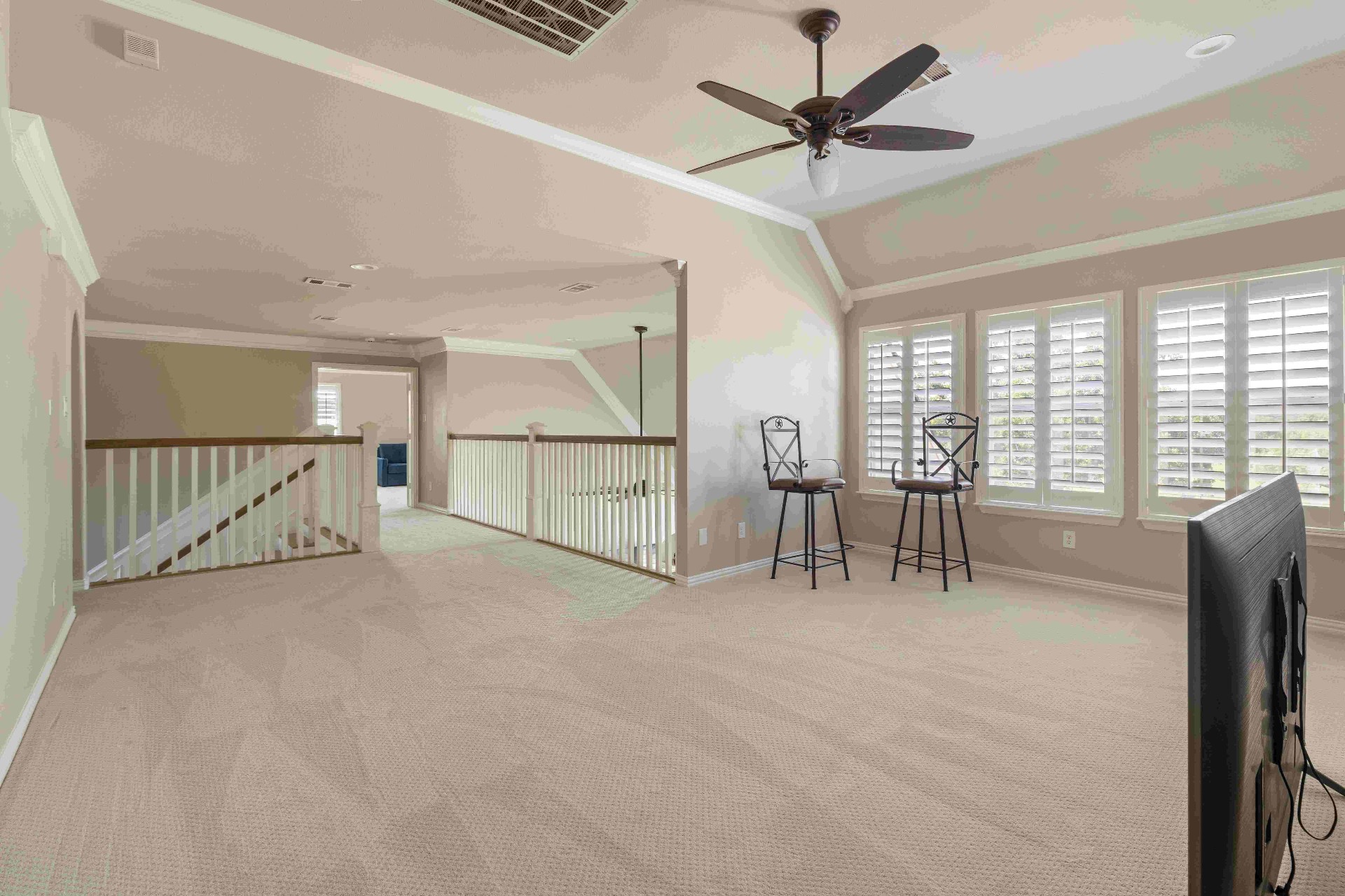 Upstairs landing with open railing and natural light