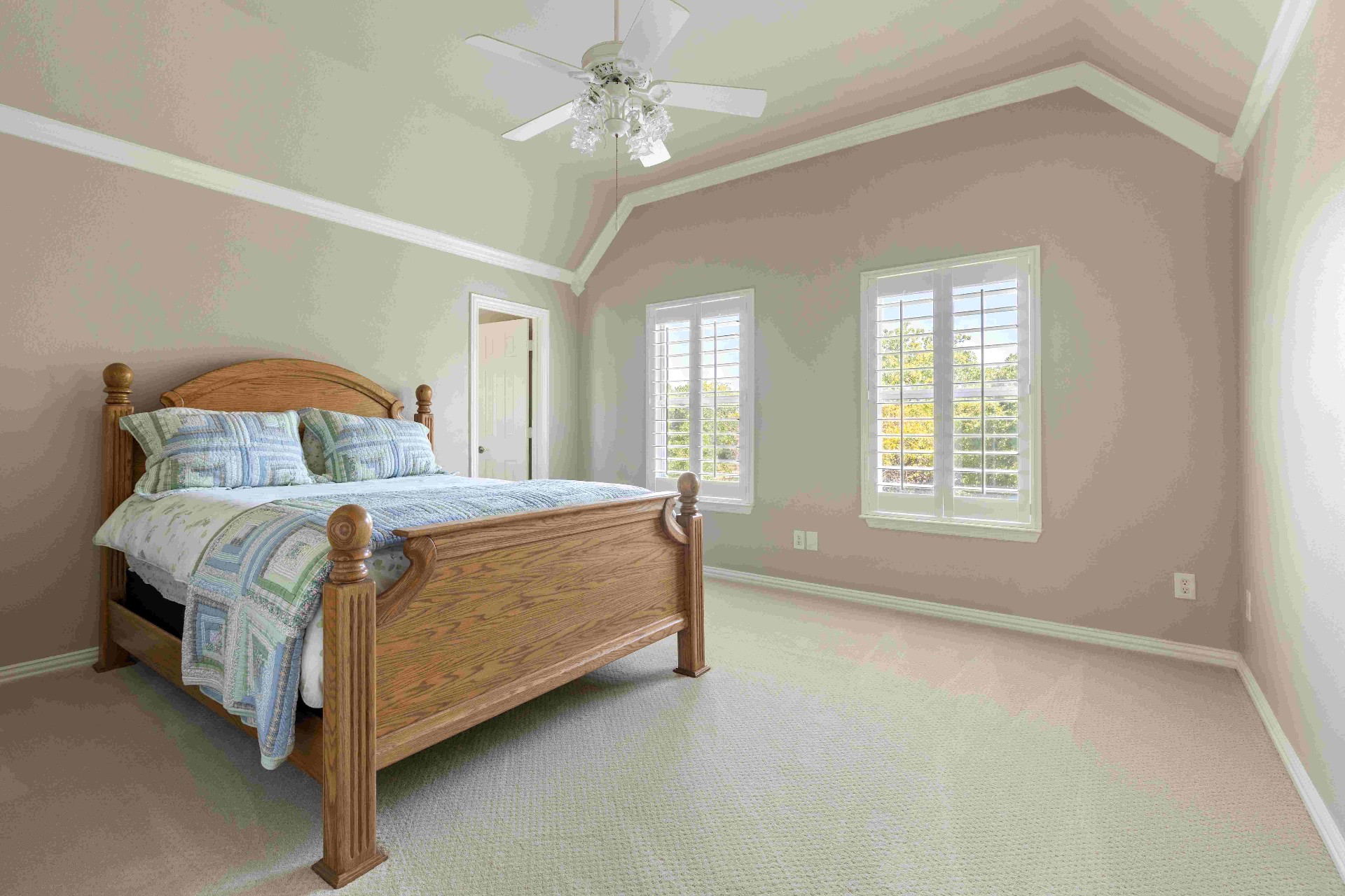 Secondary bedroom with vaulted ceiling and dual windows