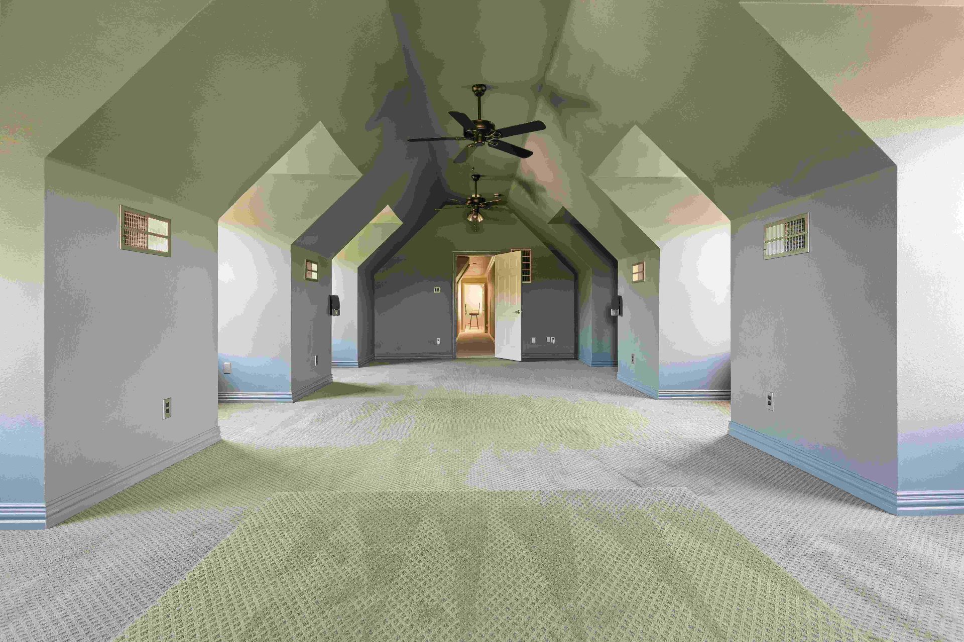 Upstairs vaulted bonus room with dual ceiling fans