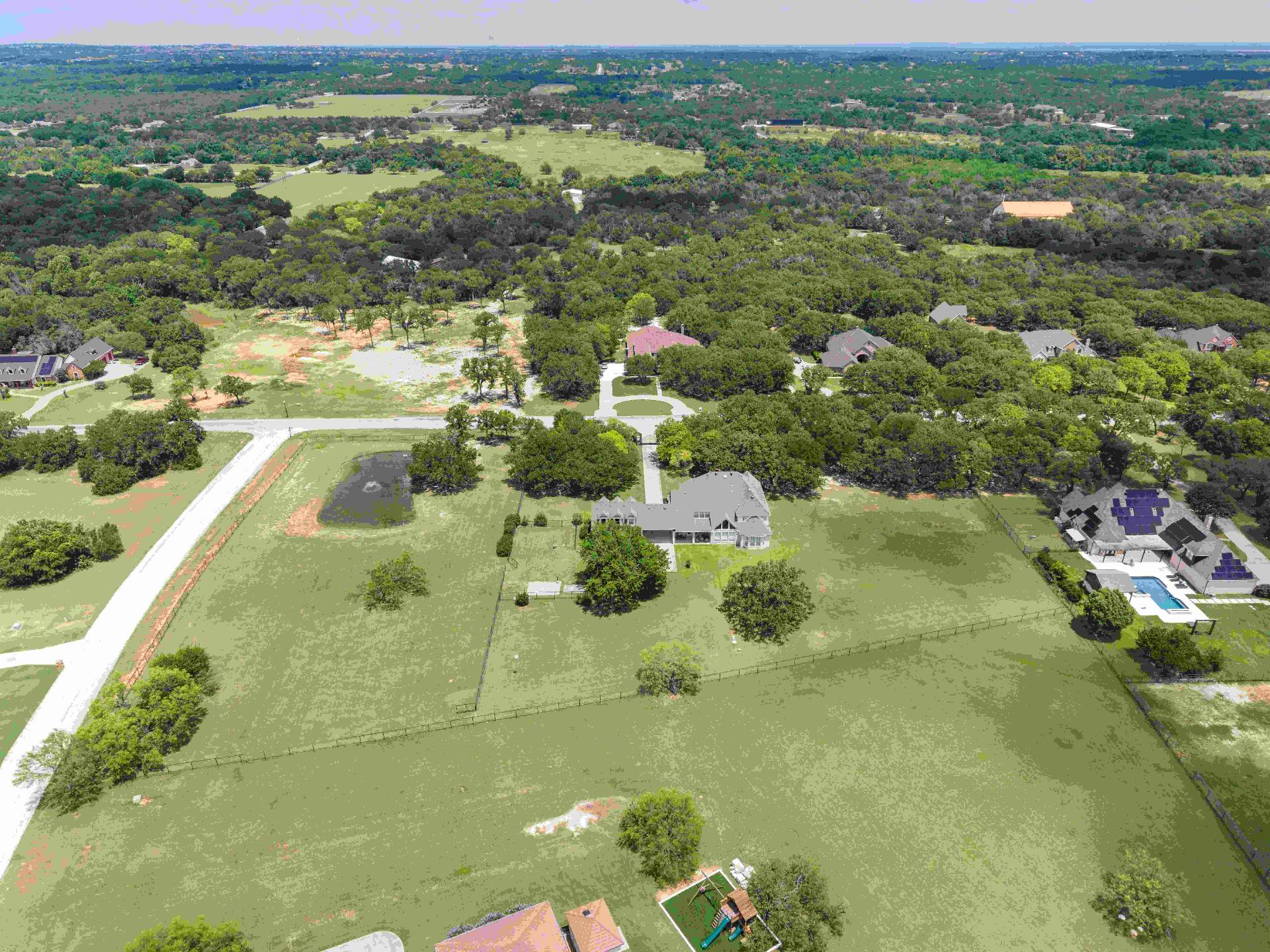 Aerial of the rear elevation and open pasture