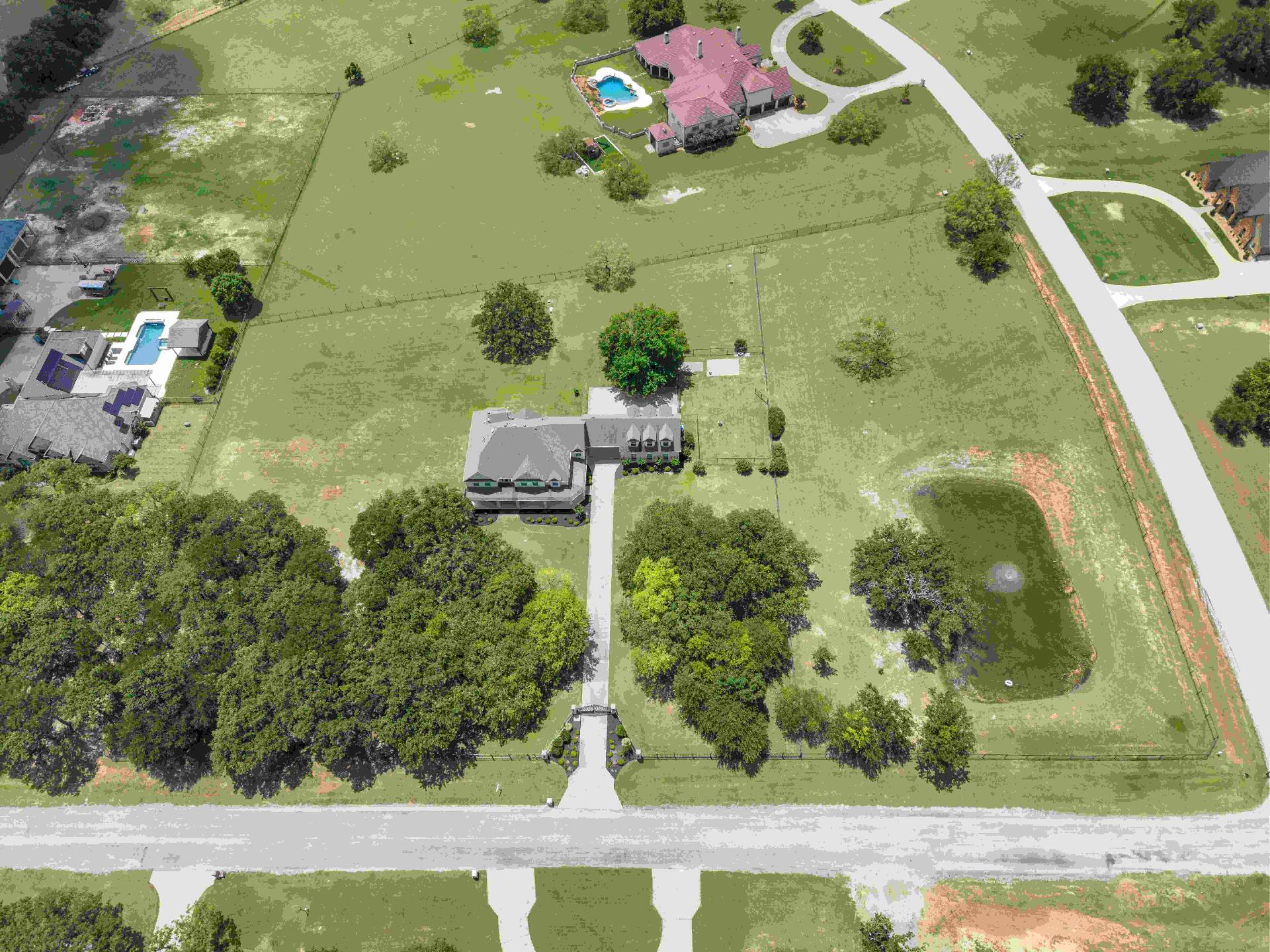 Wide aerial of the property along the corner lot